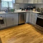 A kitchen with a sink and stove is in need of appliance repair or installation services in Boston.