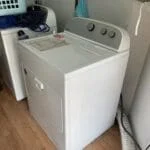 A washing machine and dryer in a room that may require appliance repair service.