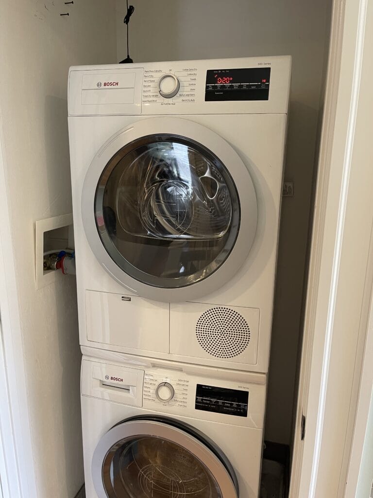 A stack of washing machines for appliance installation.